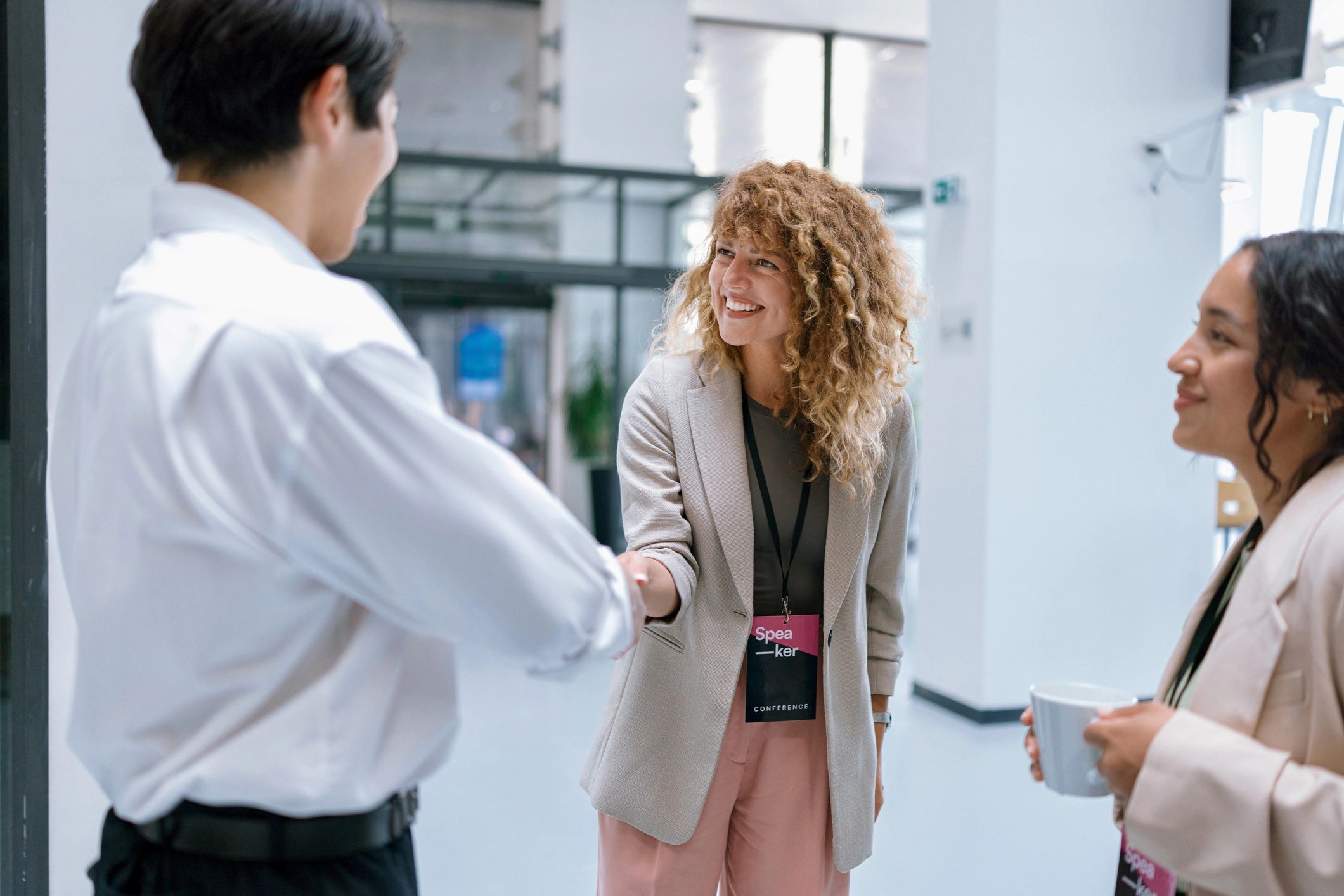 Business professionals greeting each other at an event